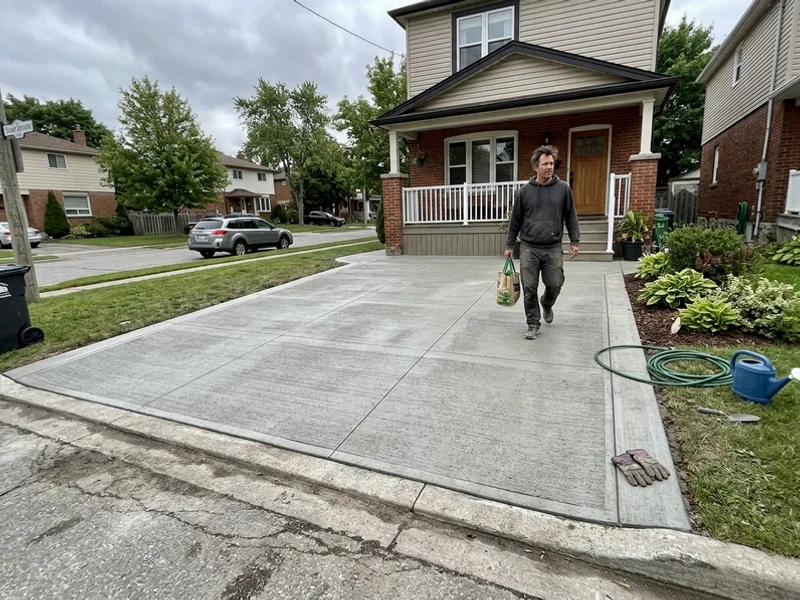 Completed broom-finished driveway with saw-cut control joints