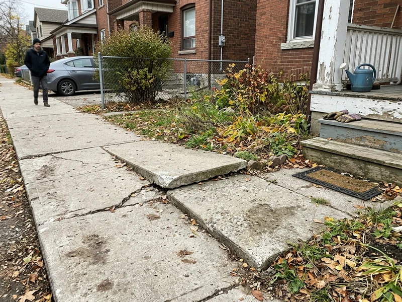 Heaved walkway with an uneven trip hazard before replacement