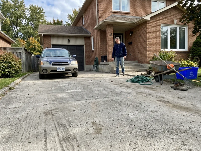 Plain grey driveway before a stamped overlay