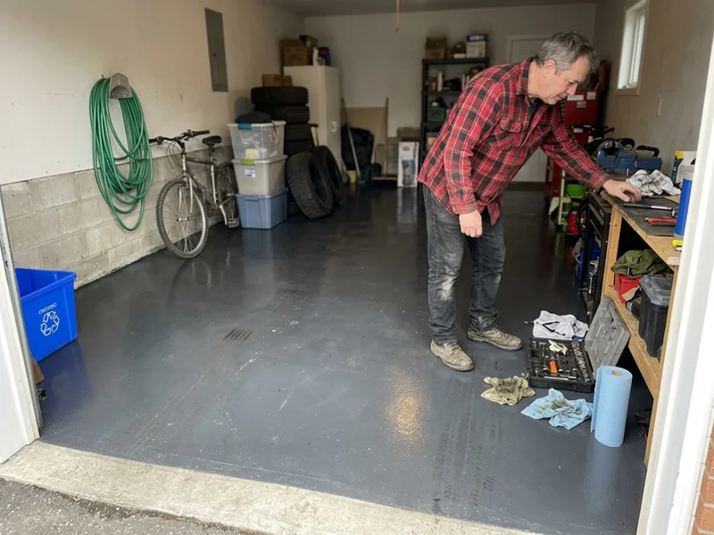 Polished garage floor with a charcoal dye and high-gloss finish